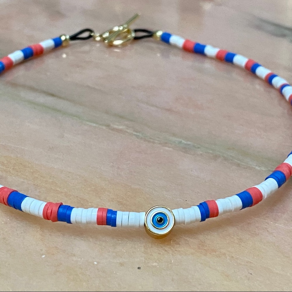 Heishi necklace with gold evil eye